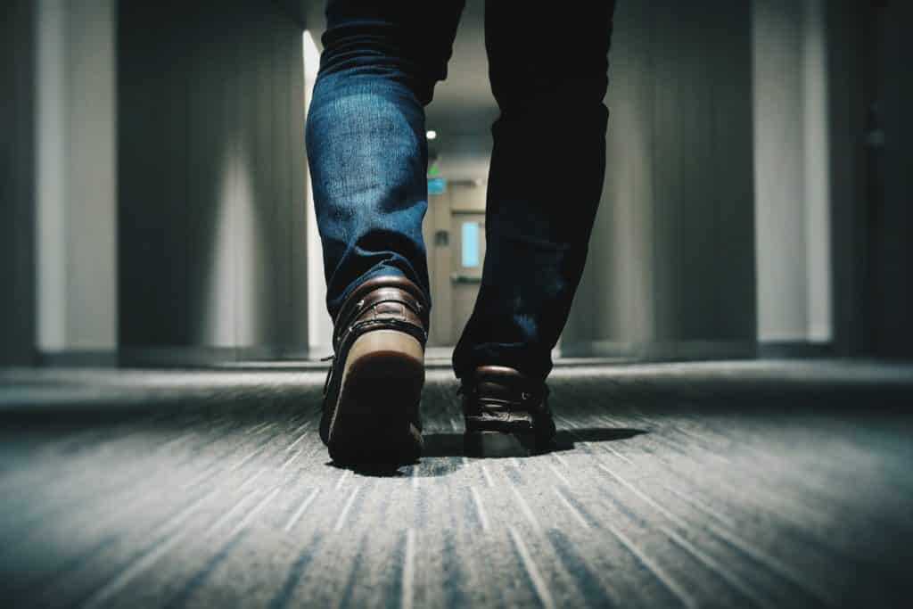 image of male walking down a hall