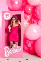 woman in pink Barbie box dressed in a pink outfit
