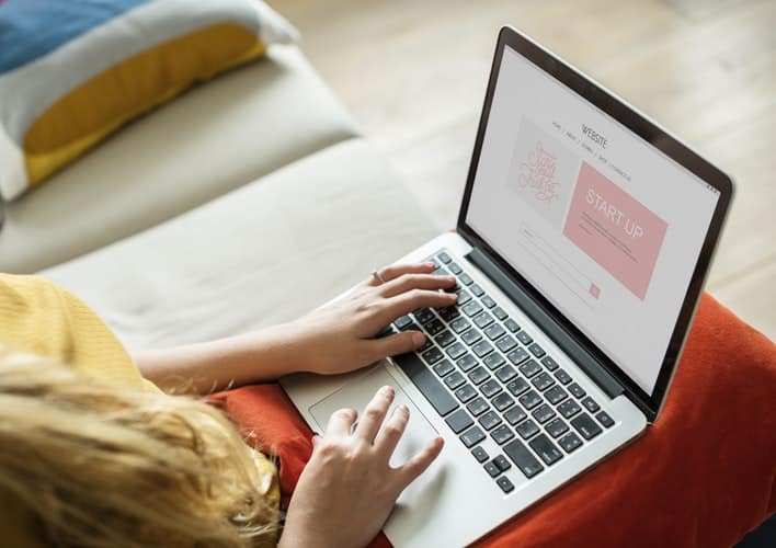 blogger online jobs for stay at home moms. Image of women writing a blog on her laptop