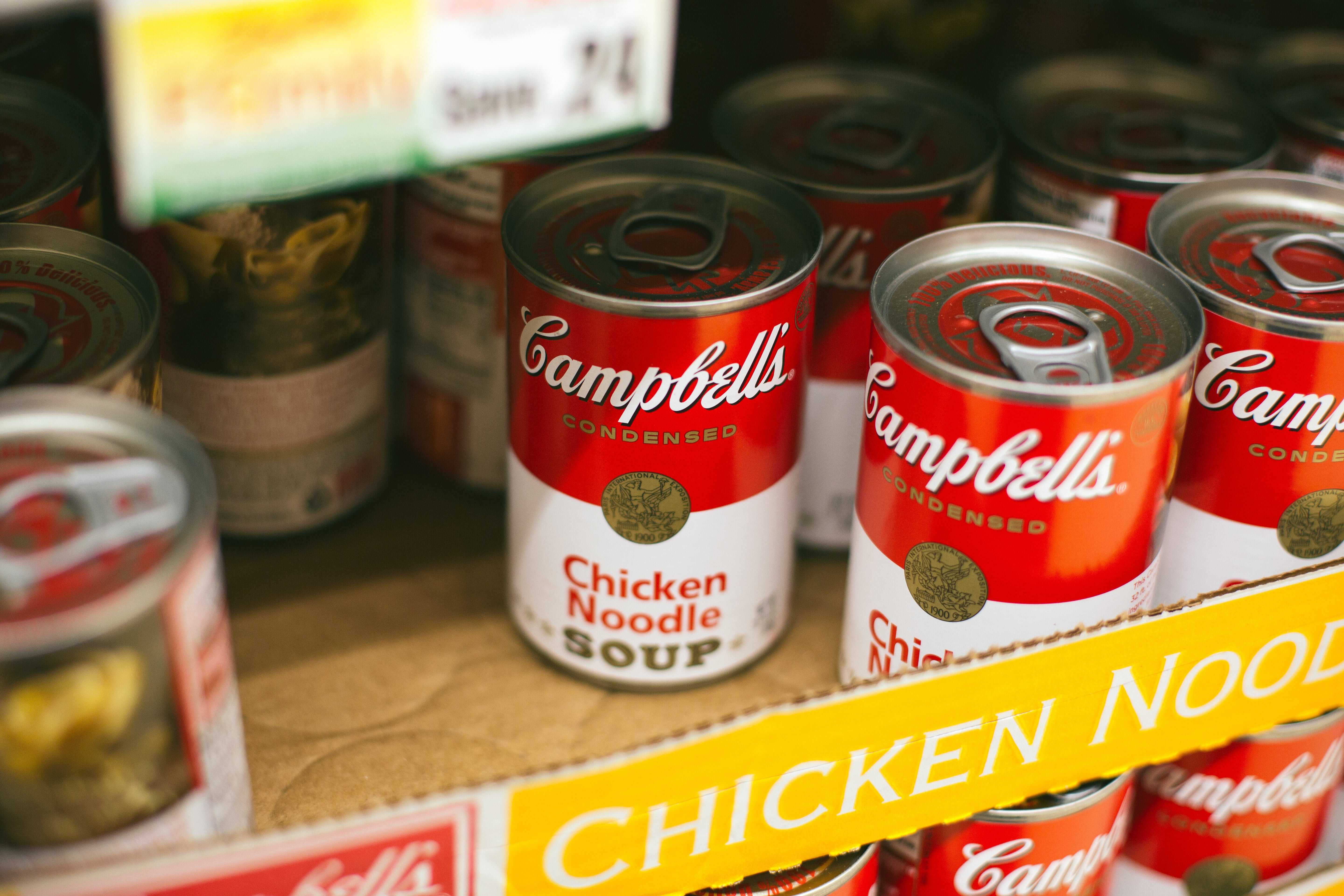 Campbell soup cans and other canned goods image.