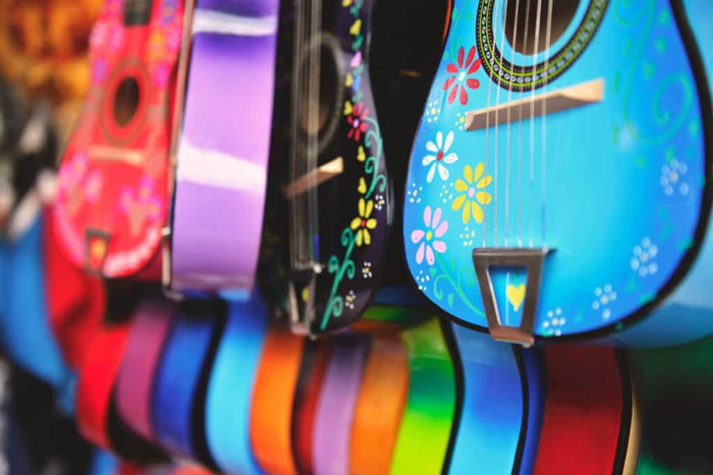 Pay off debt by flipping items for profit. Image of colorful guitars.