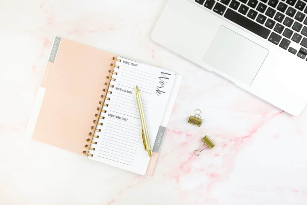 online jobs for college students in post image 2. Image of laptop and journal along with pen and paperclips.