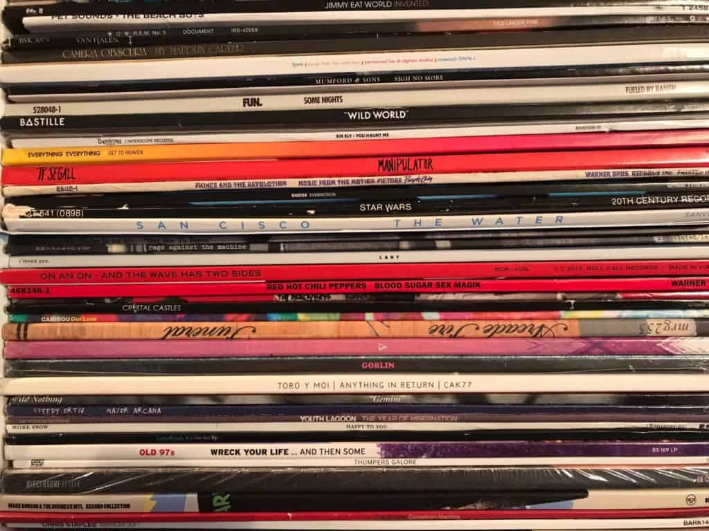 thrift store flipping records. Image of records piled on top of one antoher.