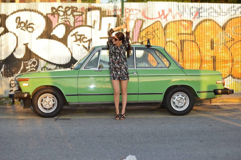 passive income ideas 2019 using your stuff. Image of woman posting in front of a classic car.