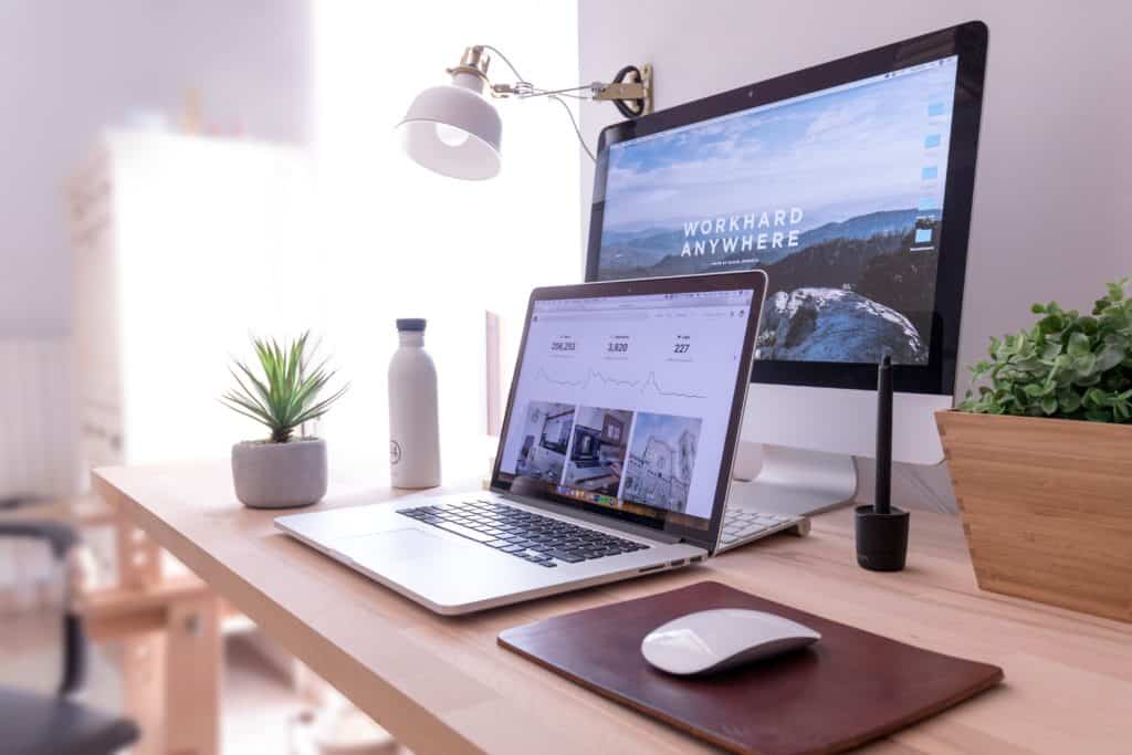 online passive income ideas, Image of laptop, mousse, plant, waiter bottle, monitor and light on desk.