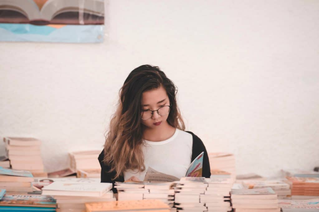 A woman looking at books in a bookstore