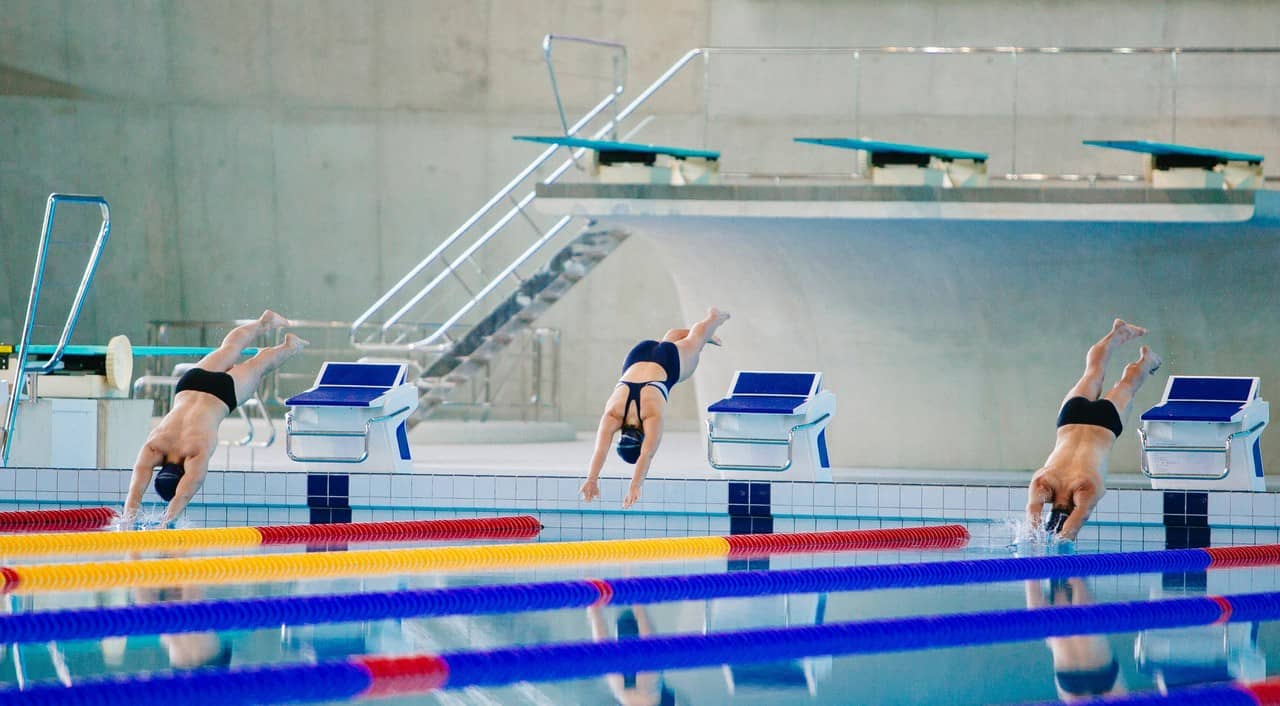 hobbies that make money - swimming - three competitive races diving into the pool commencing to race