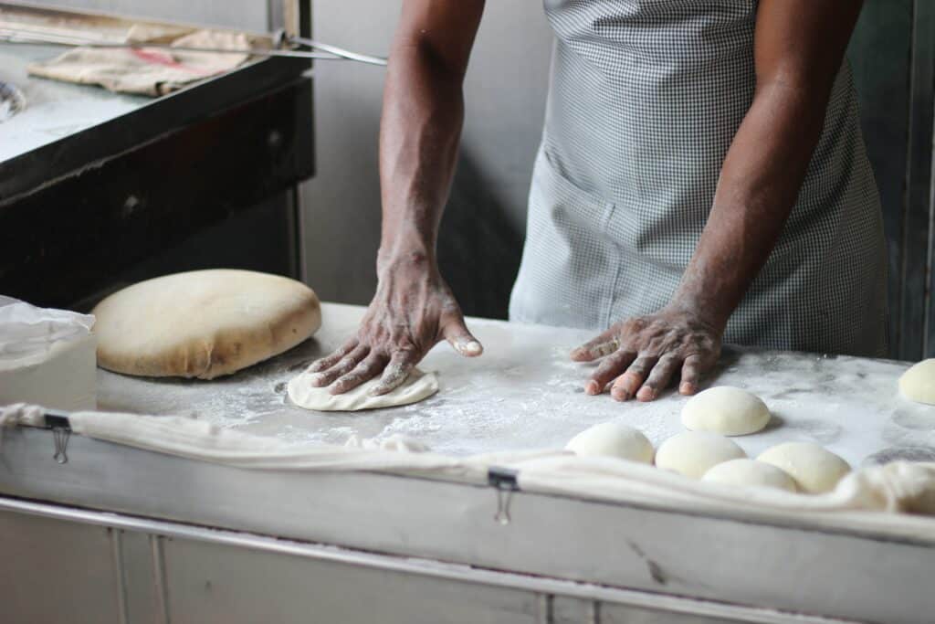 best work from home jobs at home baker image of man kneading dough.